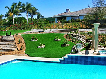 synthetic lawn surrounding residential pool